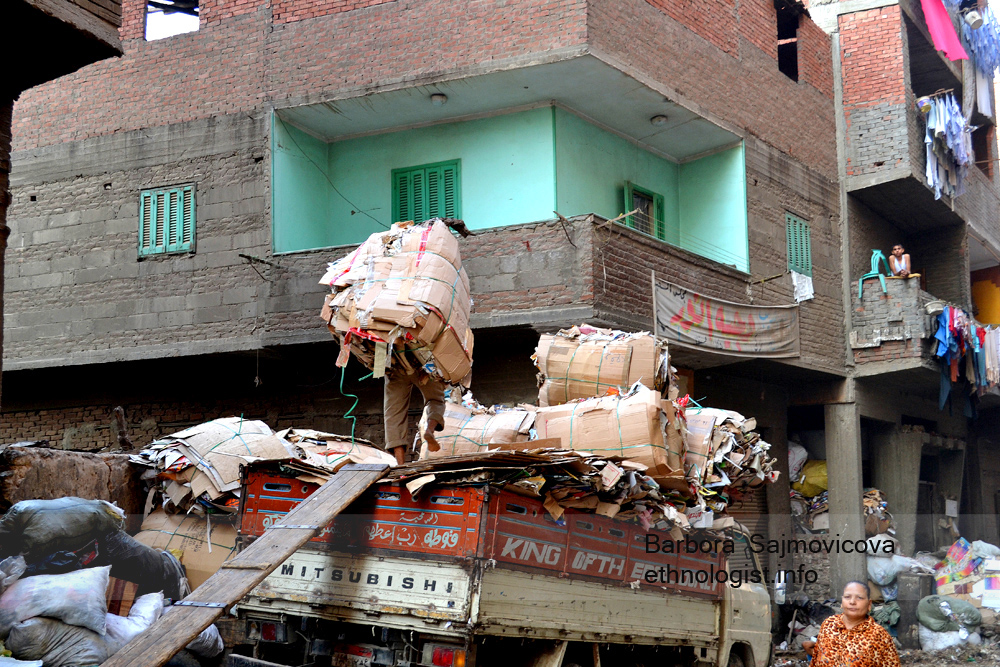 Photo: Barbora Sajmovicova The man carrying the paper load on his back to the small truck. Photo: Barbora Sajmovicova, 2011, Nikon D3100.