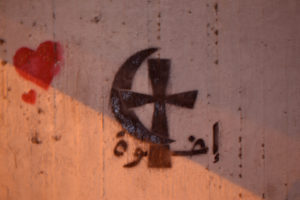 Photo: Barbora Sajmovicova Interreligious dialogue and peace captured in streets in Cairo at the night. On the wall you can see Arabic word 'iida'atan (light). Photo: Barbora Sajmovicova, 2011.
